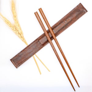Chopstick set with leather holder. The perfect gift . Color options , brown, light brown and gray. Premium wooden or stainless chopsticks.