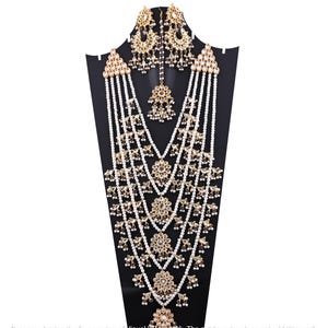 May include: A multi-strand pearl necklace with gold accents and a matching set of earrings. The necklace features multiple layers of pearls and gold embellishments, including small floral designs and mirror-like accents. The earrings are similarly adorned with pearls and gold.