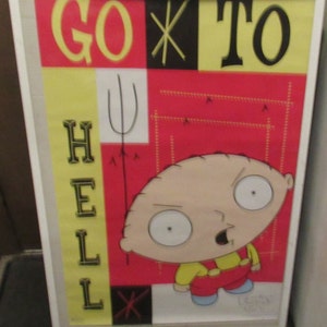 Puede incluir: Un póster enmarcado con un personaje de dibujos animados con una camisa amarilla y pantalones rojos. El póster tiene un fondo rojo con un diseño amarillo y negro. El texto en el póster dice "Go To Hell".
