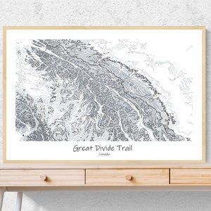May include: A black and white topographic map print of the Great Divide Trail in Canada. The map shows the trail winding through the mountains.
