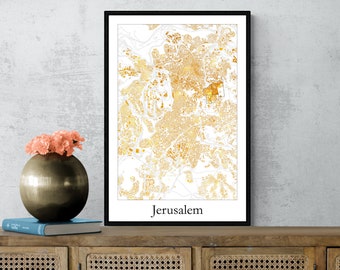 May include: Framed map print of Jerusalem in gold and white. The city map is detailed, with streets and buildings visible. The word "Jerusalem" is printed in a clean font at the bottom. The print is displayed on a wooden cabinet with a vase of flowers.