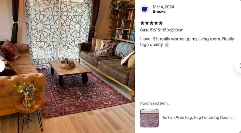 May include: A rectangular area rug featuring a dark red and navy blue intricate pattern with a decorative border. The rug measures 5 feet by 7.5 feet and is positioned on a light wood floor beneath a wooden coffee table and two brown sofas.