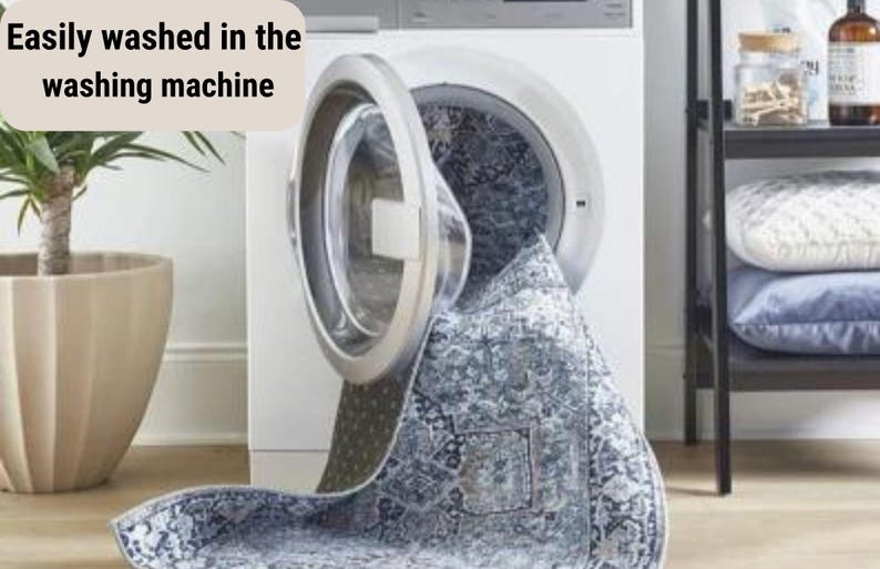 May include: A blue and white patterned rug is being washed in a white washing machine. The text "Easily washed in the washing machine" is visible in the image.