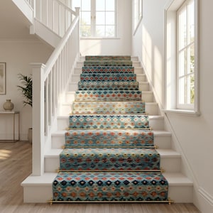 May include: A staircase runner featuring a repeating geometric pattern in shades of teal, orange, and dark blue. The runner is secured to each step with polished brass stair rods, creating a decorative accent on the white wooden staircase.