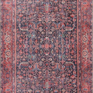 May include: A rectangular area rug featuring a dark navy blue center field with a symmetrical floral and geometric pattern in shades of red, light blue, and cream. The rug has a wide, ornate border in deep red with matching floral motifs.