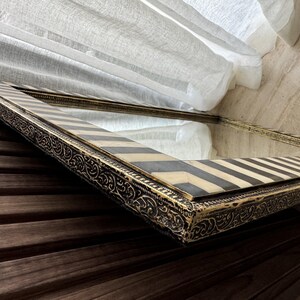 Close-up shot, gold brass trim, showing the natural tone variations in the cream white  bone and dark contrast stripes.