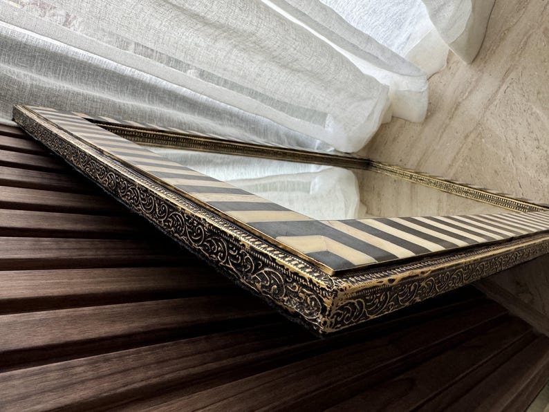 Close-up shot, gold brass trim, showing the natural tone variations in the cream white  bone and dark contrast stripes.