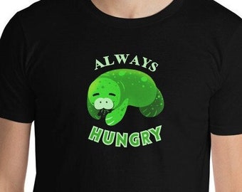Cute Green ManaTEE shirt! Snacking Sea Cow "Always Hungry" Unisex Short sleeved Black shirt. Each purchase goes towards habitat conservation