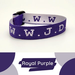 May include: A purple woven wristband with white lettering that reads "W.W.J.D.". The wristband is made of a soft, comfortable material and is adjustable to fit most wrists.