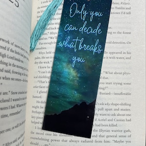 May include: A blue and green bookmark with a galaxy design and the text "Only you can decide what breaks you".