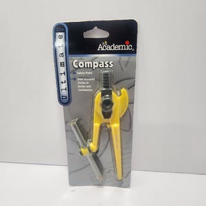 May include: A yellow and silver compass packaged on a gray and black cardboard backing. The package reads "The Ultimate Academic Compass" and includes text about drawing accurate circles in inches and centimeters. The compass is a school supply.