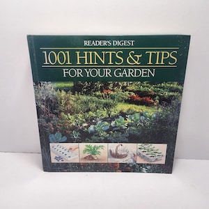 May include: A Reader's Digest book titled "1001 Hints & Tips For Your Garden." The cover features a vibrant garden scene with various plants and vegetables. The book's title is in white and gold lettering against a dark green background.