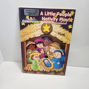 May include: A Little People Nativity Play! Giant Coloring and Activity Book with a dark purple cover featuring a cartoon illustration of a nativity scene under a yellow star. The cover includes the text A Little People Nativity Play! and a sticker.
