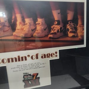 Peut inclure: Publicit&eacute; encadr&eacute;e pr&eacute;sentant plusieurs paires de baskets Nike blanches et noires. Le texte "Bix 7 - 1995 Bix 7" est affich&eacute; en haut. La phrase "Comin' of age!" est &eacute;galement visible, ainsi que du texte suppl&eacute;mentaire et le logo Bix 7.