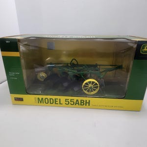 May include: A 1/16 scale die-cast metal replica of a 1948 Model 55ABH three bottom plow on steel, enclosed in a green and yellow box. The toy features dark green metal components, black plow blades, and bright yellow spoked wheels.