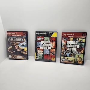 May include: Three PlayStation 2 video game cases. Titles include "Call of Duty 2: Big Red One", "Grand Theft Auto III", and "Grand Theft Auto: San Andreas". The cases are black with game art and text.