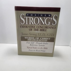 May include: A hardcover book titled "The New Strong's Exhaustive Concordance of the Bible." The book has a beige cover with burgundy accents and features the author's name and additional details about the book's contents.