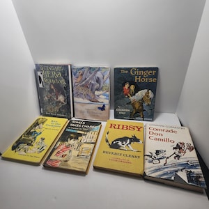 May include: A collection of seven vintage hardcover books featuring illustrated covers, including titles such as Standard Hero Behavior, Just So Stories, The Ginger Horse, Key to the Treasure, Tomas Takes Charge, Ribsy by Beverly Cleary, and Comrade Don Camillo.