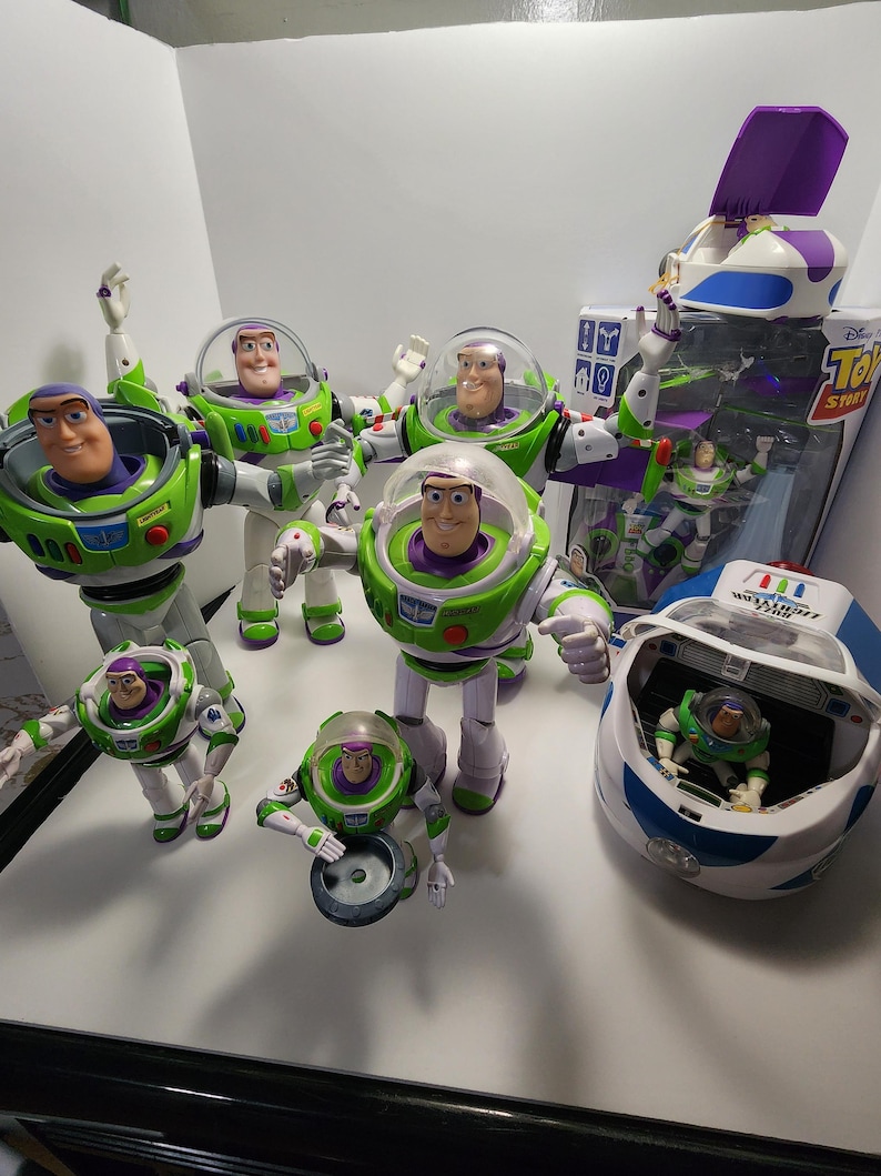 May include: A collection of seven Buzz Lightyear action figures from the Toy Story franchise. The figures are in various poses and include a spaceship, a jetpack, and a space ranger helmet.
