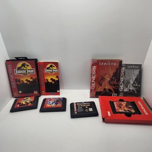 Peut inclure: Une collection de cartouches et de boîtes de jeux vidéo Sega Genesis, dont Jurassic Park, Le Roi Lion et Sonic the Hedgehog.