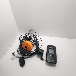 May include: A white ceramic mug with a black handle and the text "But First, Coffee" in a handwritten style. The mug is on a white surface. The mug is 4 inches tall.