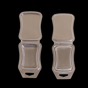 May include: Two clear plastic containers with hinged lids. The containers are designed to hold small items, such as soap or jewelry.