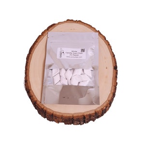 May include: A silver pouch containing 25 white candle dye chips. The pouch has a label that reads "White Candle Dye Chips 25 Pieces" and "porturban.com".