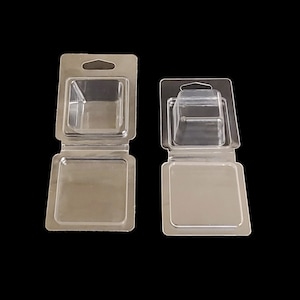 May include: Two clear plastic clamshell packaging boxes with hang holes. The boxes are open and the top portion is folded back. The boxes are empty.