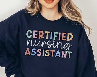 May include: A navy blue sweatshirt with the text "CERTIFIED nursing ASSISTANT" in colorful letters.