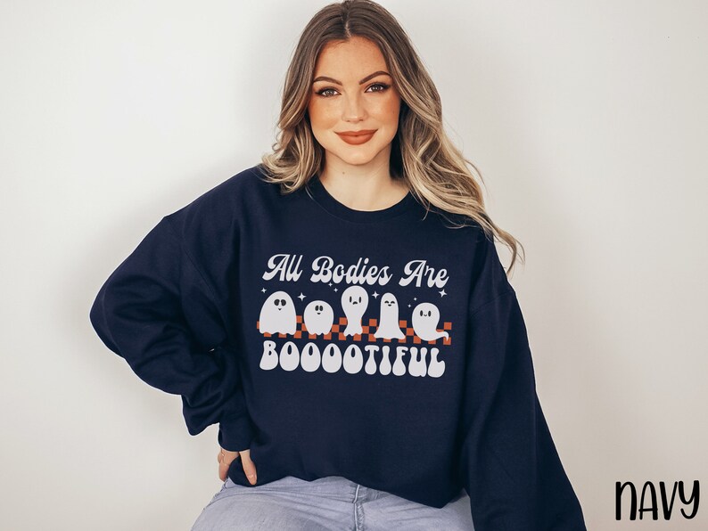May include: A navy blue sweatshirt with a white graphic of ghosts and the text "All Bodies Are Boootiful".