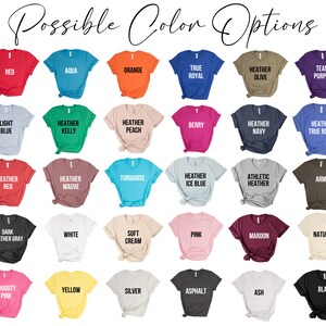 May include: A chart showing 40 different t-shirt colors with their names. The colors include red, aqua, orange, true royal, heather olive, team purple, light blue, heather kelly, heather peach, berry, heather navy, heather true royal, heather red, heather mauve, turquoise, heather ice blue, athletic heather, army, dark heather gray, white, soft cream, pink, maroon, natural, charity pink, yellow, silver, asphalt, ash, and black.