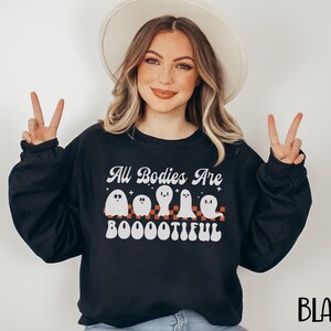 May include: Black sweatshirt with a white graphic of ghosts and the text "All Bodies Are Boootiful".