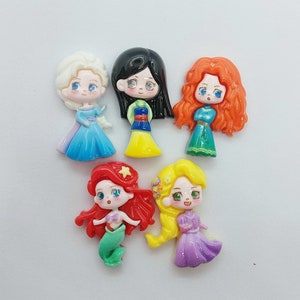 May include: Set of six colorful princess figurines with cartoon faces and long hair. The princesses are wearing different colored dresses and have different hair colors.