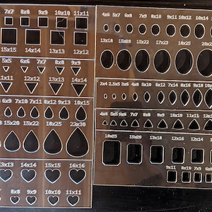 May include: Clear acrylic templates with various shapes and sizes, including squares, circles, triangles, teardrops, and hearts. Measurements are in inches, ranging from 4x4 to 22x30.