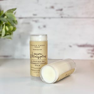 May include: A brown and white tube of lemon eucalyptus bug deterrent lotion stick from Tickle Creek Soap. The tube is labeled "All Natural Bug Deterrent Lotion Stick" and "Lemon Eucalyptus".