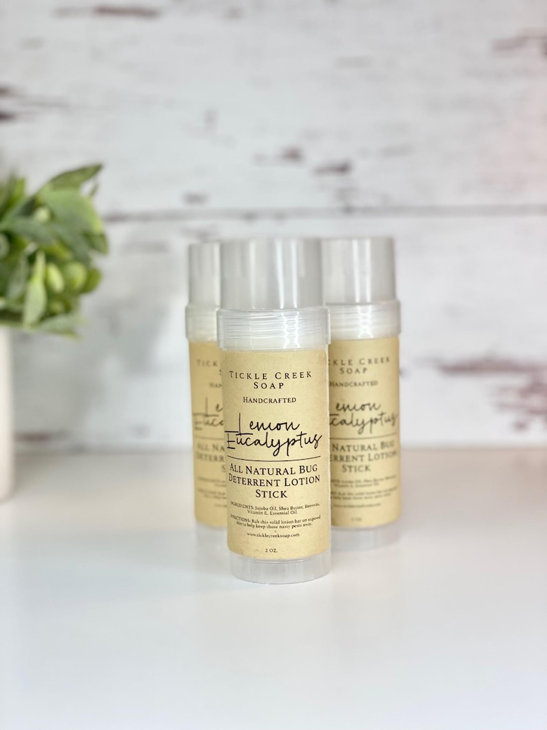May include: Three brown and white labeled tubes of lemon eucalyptus bug deterrent lotion stick. The label reads "Tickle Creek Soap Handcrafted Lemon Eucalyptus All Natural Bug Deterrent Lotion Stick".