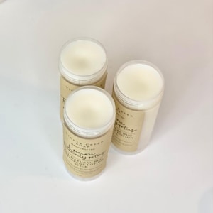 May include: Three white deodorant sticks with brown labels. The labels read "Pickle Creek Soap", "Handcrafted", "Lemon Eucalyptus", "Natural Bug Repellent Deodorant Stick", and "Eucalyptus".