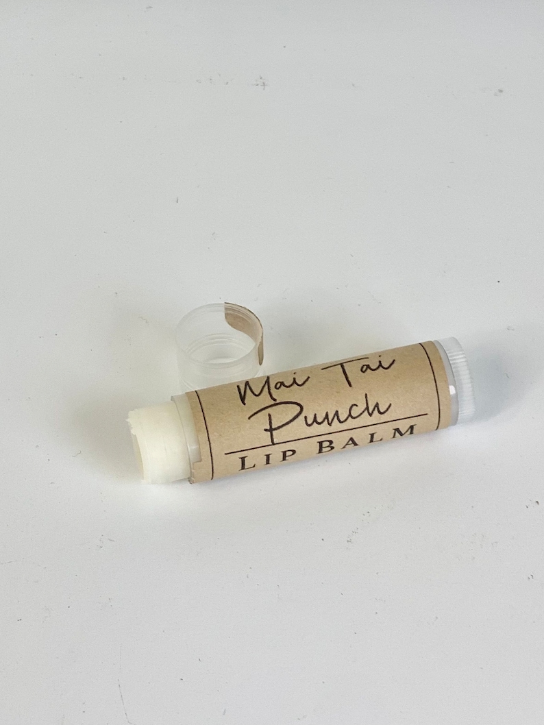 May include: A white lip balm tube with a brown label that reads "Mai Tai Punch Lip Balm".