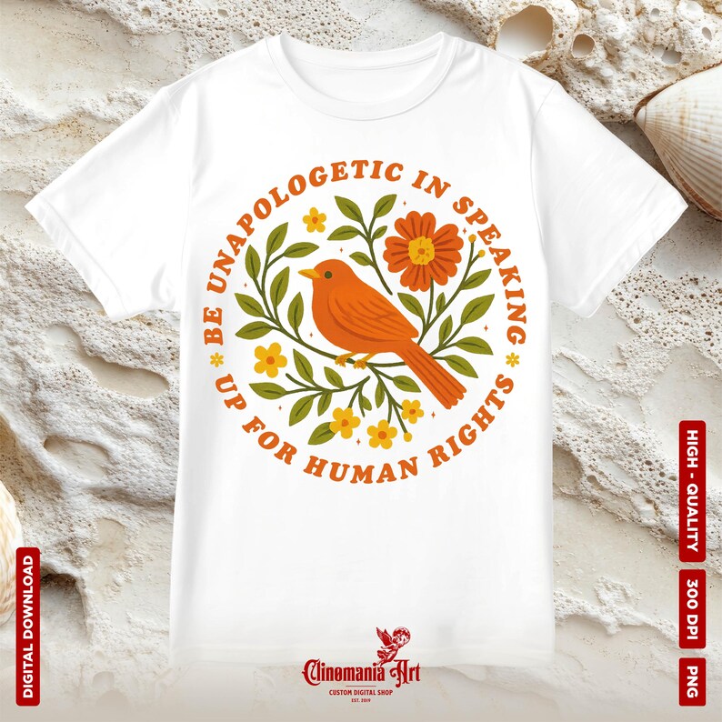 May include: White t-shirt with a circular design featuring an orange bird, flowers, and the text "BE UNAPOLOGETIC IN SPEAKING UP FOR HUMAN RIGHTS." The design is surrounded by a green floral wreath.