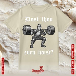 May include: Beige t-shirt with a black and white illustration of a knight lifting a barbell. The text "Dost thou even hoist?" is printed above and below the knight. The shirt also has the text "Clinomania Art" and "Custom Digital Shop" printed on it.