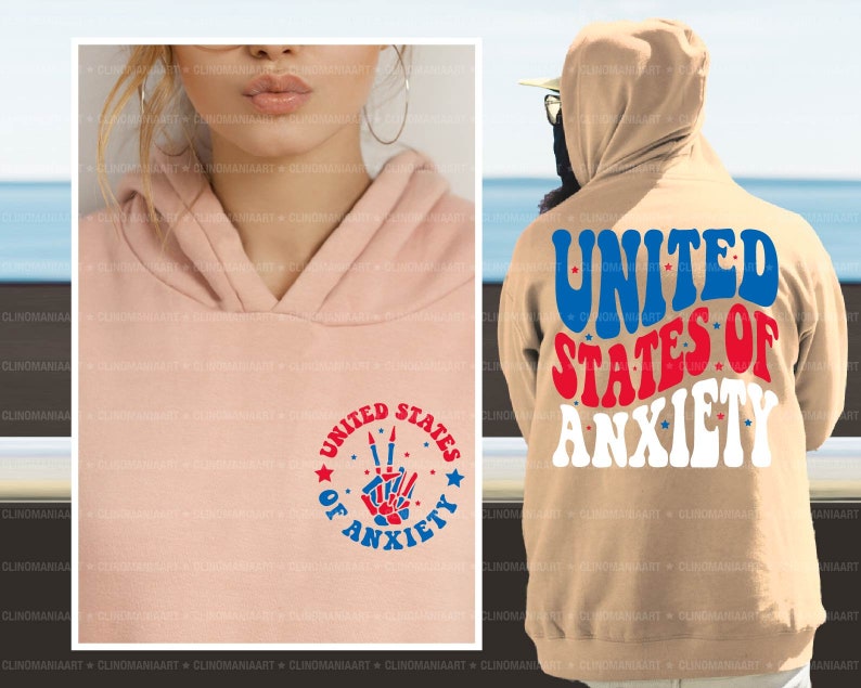Peut inclure: Un sweat-shirt rose et beige avec un graphique rouge, blanc et bleu qui dit "United States of Anxiety" avec un signe de paix et des &eacute;toiles.
