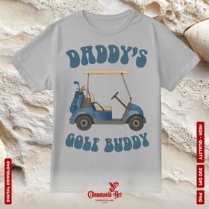 May include: A light gray t-shirt with the text "DADDY'S GOLF BUDDY" in blue. The design features a blue golf cart with golf clubs. The shirt is a digital download.