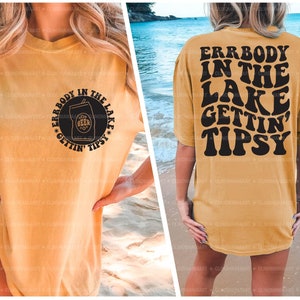 May include: A yellow t-shirt with a black graphic that says "Errbody in the lake gettin' tipsy" on the back and a black graphic of a beer can with the text "Errbody in the lake gettin' tipsy" on the front.