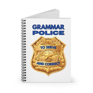 May include: A white spiral notebook with a gold badge design. The badge has a blue ribbon with the text "Grammar Police" and "To Serve and Correct".