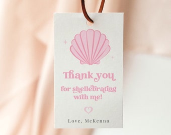 May include: A white thank you tag with a pink seashell illustration. The text reads "Thank you for shell-ebrating with me! Love, McKenna".