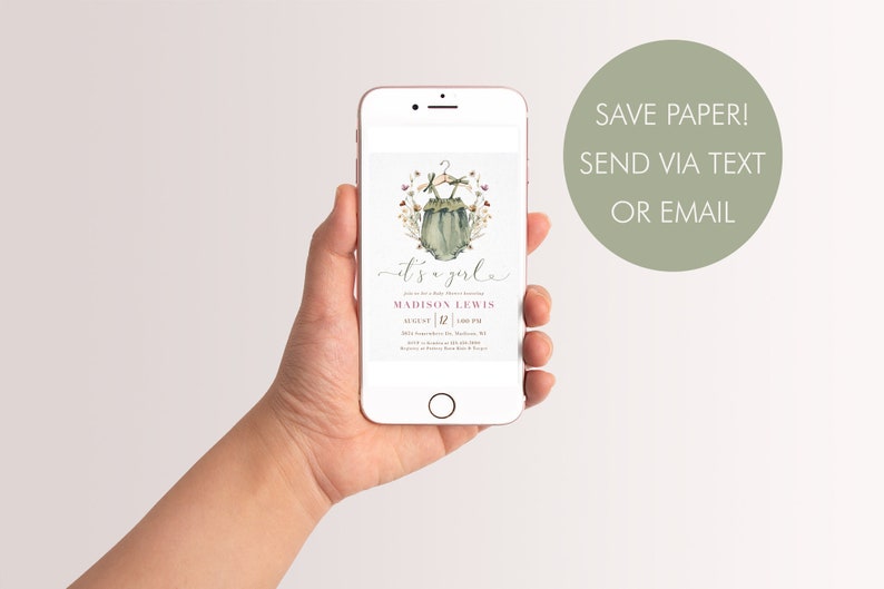 May include: A digital baby shower invitation on a smartphone screen. The invitation features a watercolor illustration of a baby onesie with flowers and the text "it's a girl" in pink and white. The invitation also includes the name "MADISON LEWIS" and the date and time of the shower.