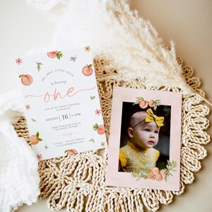 May include: Peach-themed first birthday party invitation with a pink background and peach illustrations. The invitation includes the text "Our Sweet Little Peach is turning one" and details about the party, including the date, time, and location. A photo of a baby girl is included in a separate frame.