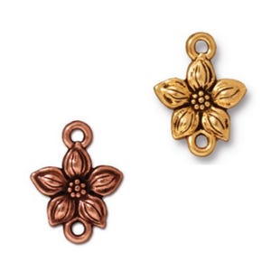 May include: Two metal flower charms. One is gold-colored, the other is copper-colored. Each charm has a flower shape with five petals, a loop at the top, and a small hole at the bottom.