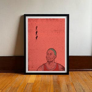 Puede incluir: Una impresión enmarcada de un jugador de baloncesto con una camiseta roja y una diadema verde. El fondo es de color rosa con iconos de alfiler negros.