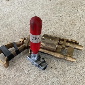 May include: A set of three ceramic mugs with a speckled, matte finish. The mugs are in shades of cream, light gray, and dark gray. Each mug has a simple, minimalist design and a rounded handle.